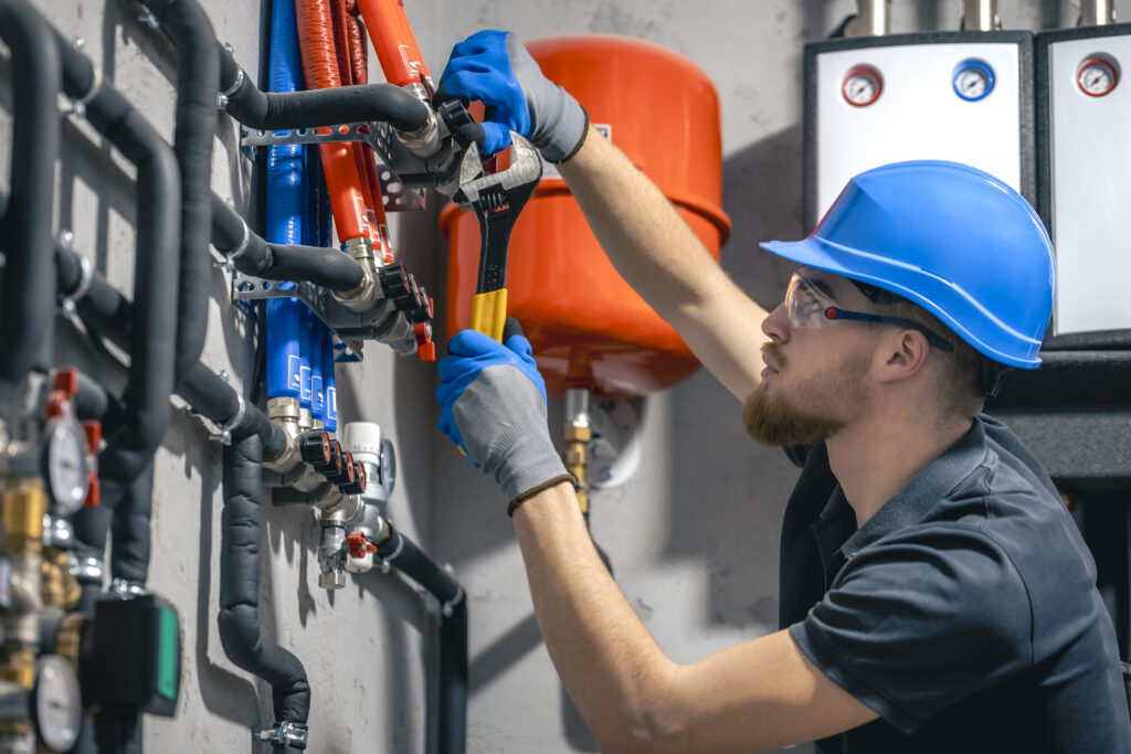 man-installs-heating-system-house-checks-pipes-with-wrench - exploitation